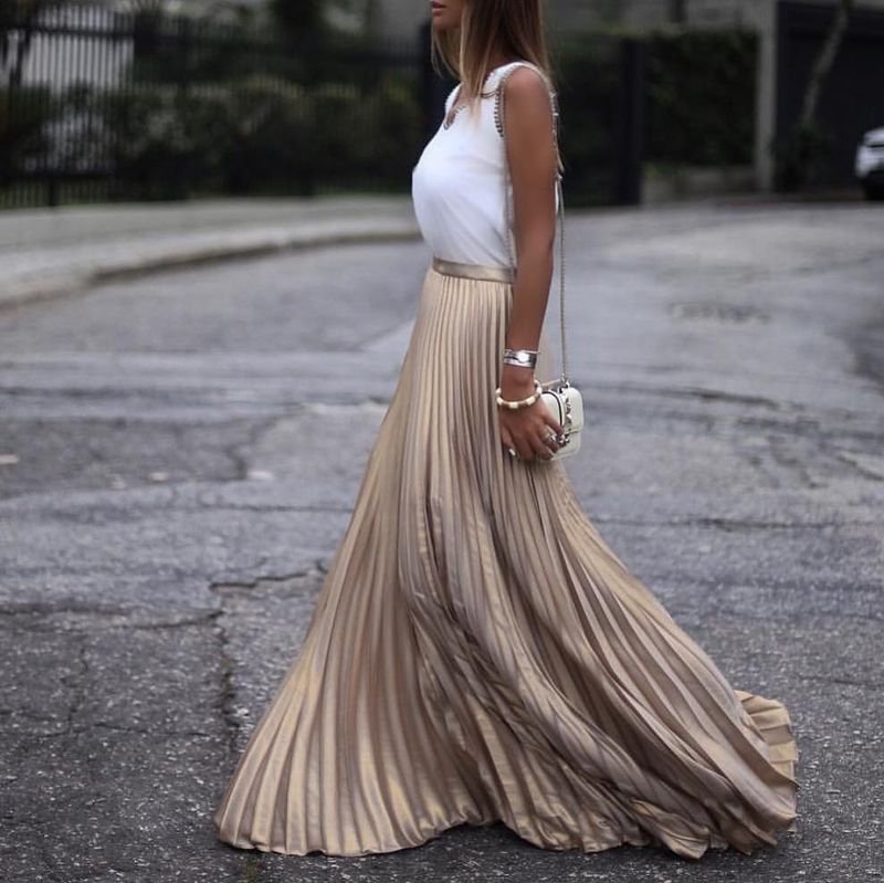 Night out outfit with maxi metallic colored skirt played down by a white tank top