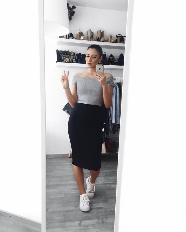 On trend combo of a black fitting pencil skirt and an equally 'hip' off-shoulder grey top