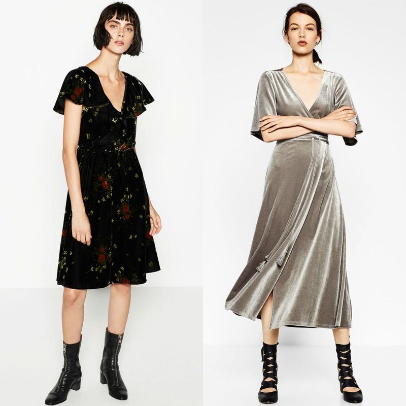 Woman wearing a black floral wrap dress with short sleeves and black ankle boots, alongside a woman in a gray velvet wrap dress with a deep V-neck and black lace-up heels