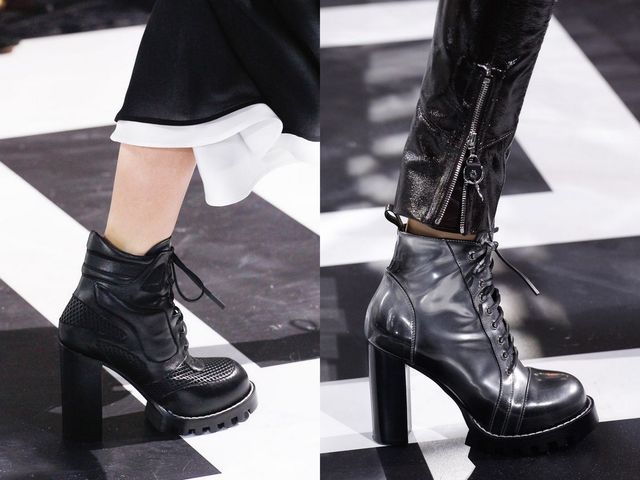 Close-up of black platform ankle boots with lace-up detail and textured panels