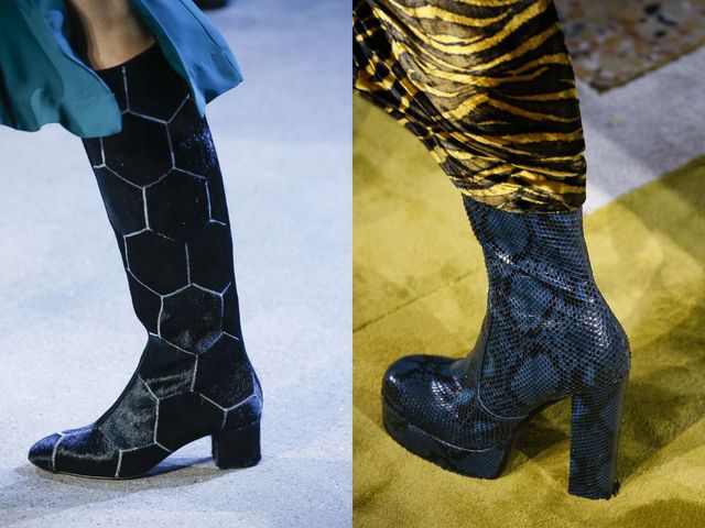 Close-up of black hexagon-patterned knee-high boots and blue snake-print platform boots on a runway