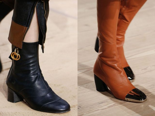Close-up of two pairs of ankle boots: one in navy leather with a zip and block heel, the other in orange leather with a pointed toe and chunky heel