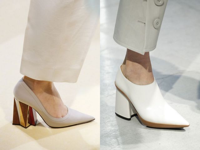 Close-up of two pairs of high-heeled shoes, one in light gray leather with a geometric heel and the other in white leather with a pointed toe and block heel