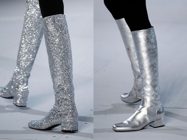 Close-up of silver glitter knee-high boots and shiny silver ankle boots on a runway