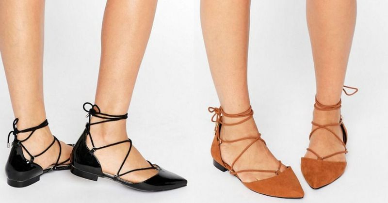 Close-up of two pairs of pointed-toe flats, one in black patent leather and the other in tan suede, both with lace-up ankle ties