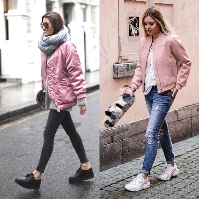 Woman wearing a pink bomber jacket, gray sweater, black skinny jeans, and black sneakers walking on a city street; woman in a pink bomber jacket, white blouse, distressed jeans, and white sneakers holding a fur clutch