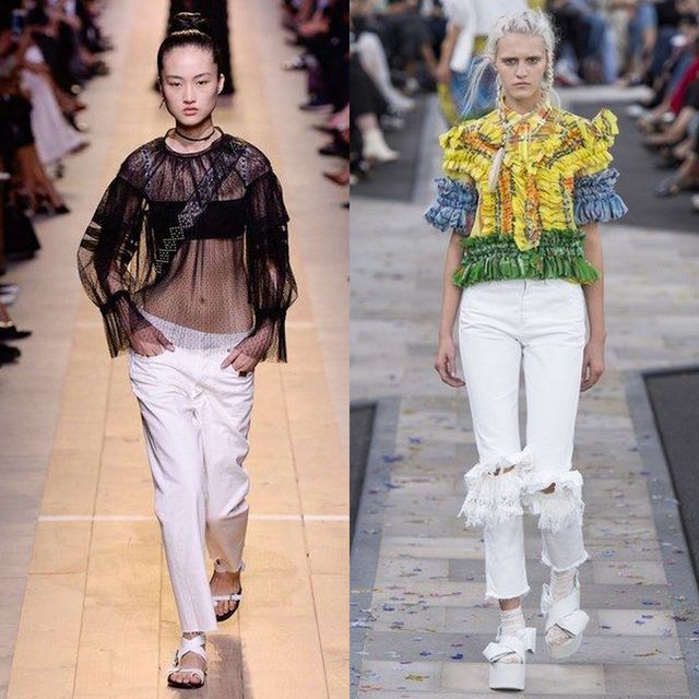 Woman wearing a black sheer long-sleeve top, white distressed jeans, and white sandals, alongside another woman in a colorful ruffled top and white ripped jeans with white platform shoes