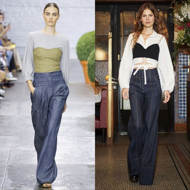 Woman wearing a gray long-sleeve top with a green corset, high-waisted blue wide-leg trousers and black platform shoes