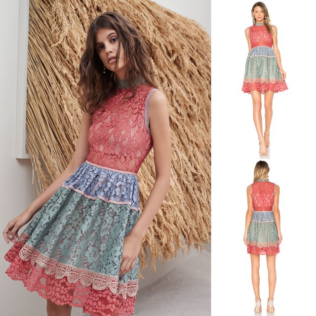 Woman wearing a pink and blue lace dress with a fitted bodice and flared skirt, paired with nude heels