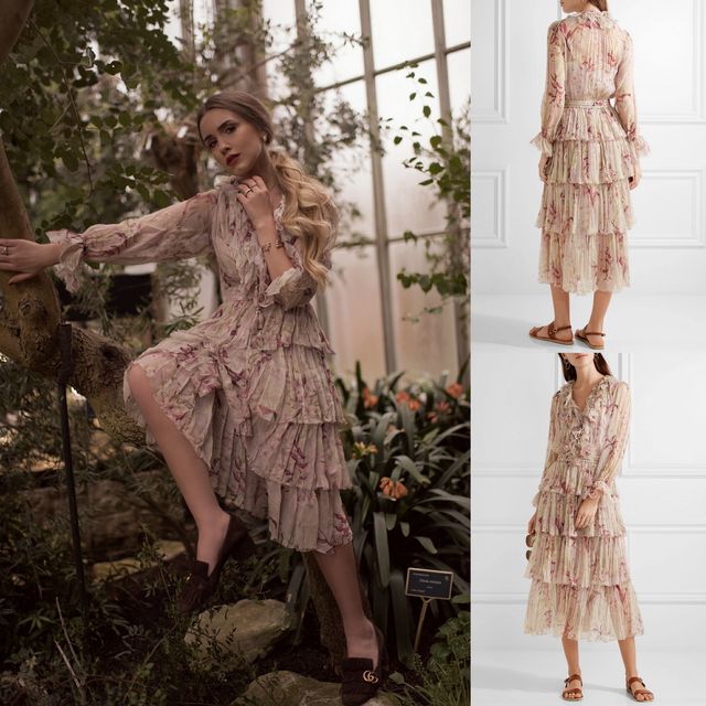 Woman wearing a pink floral tiered midi dress with long sleeves and brown slide sandals in a greenhouse setting