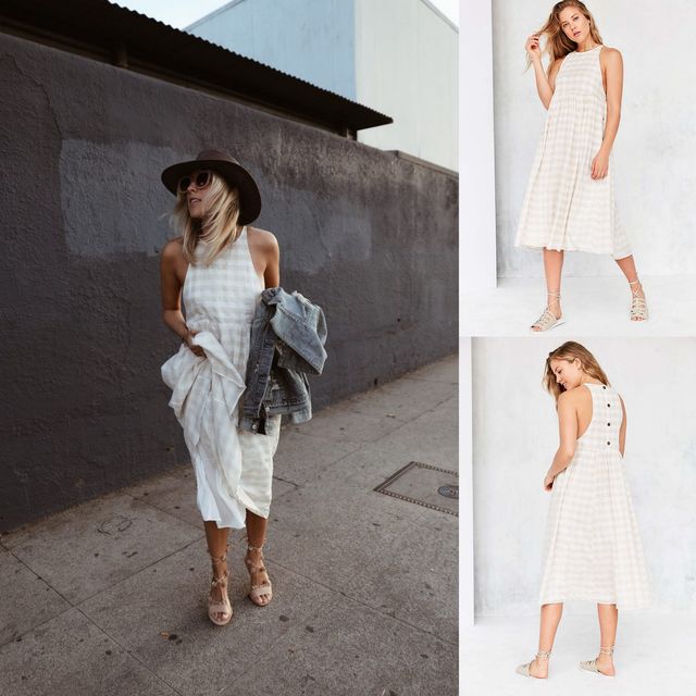 Woman wearing a white and beige checkered midi dress, denim jacket, and beige strappy sandals with a wide-brimmed hat