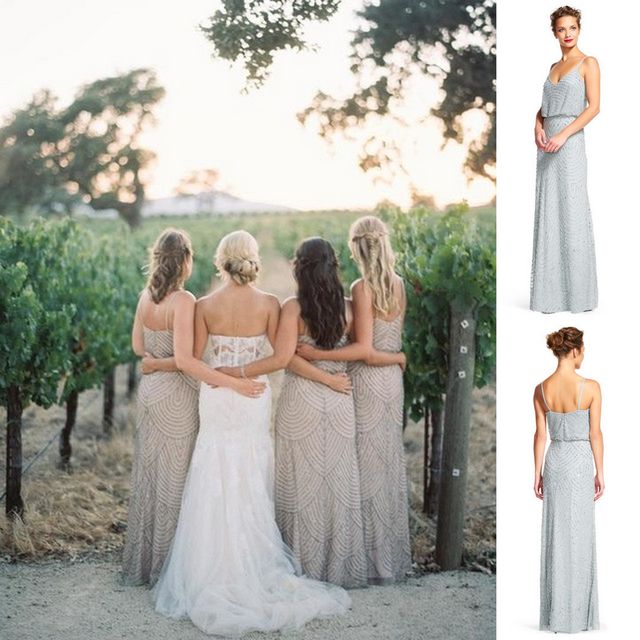 Women in a white lace wedding gown and silver sequin bridesmaid dresses standing in a vineyard at sunset