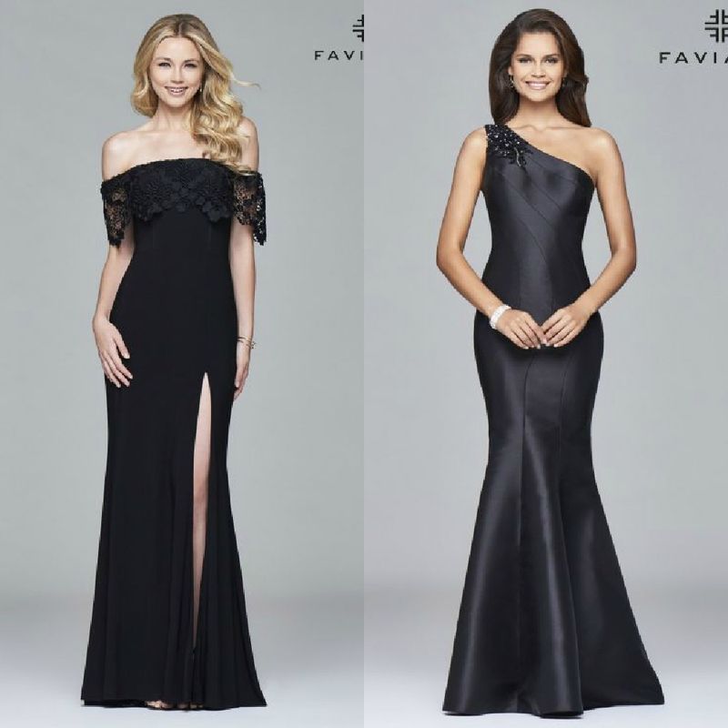 Two women in black evening gowns; one wearing an off-the-shoulder gown with lace detailing and a thigh-high slit, the other in a one-shoulder fitted gown with a flared hem