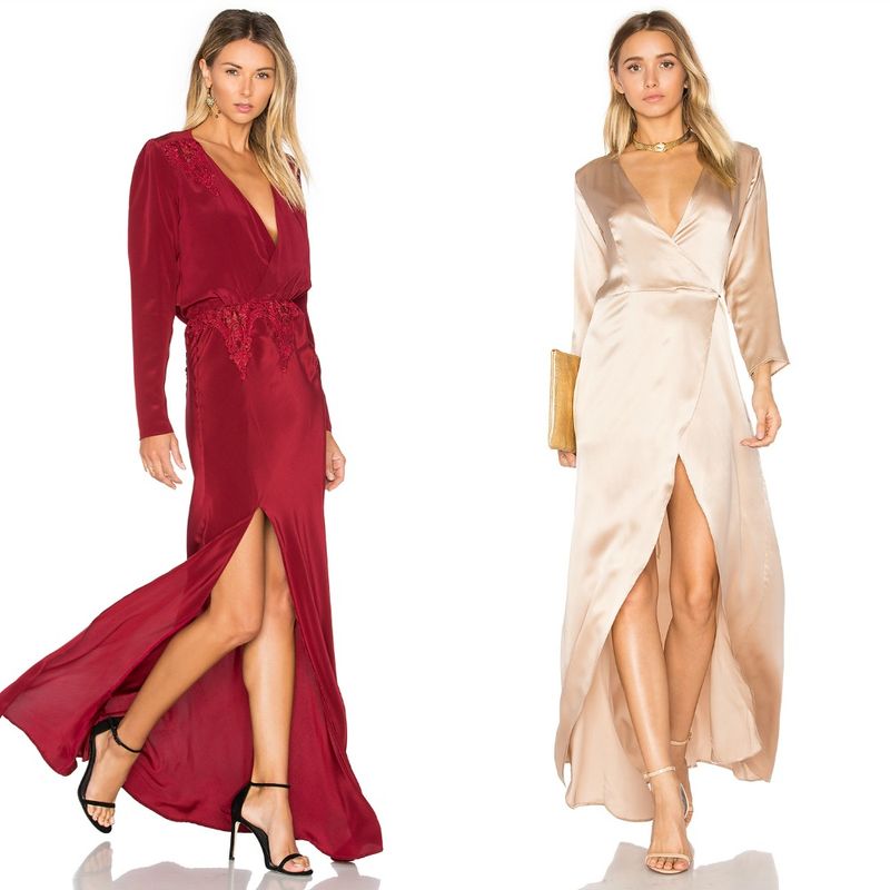 Woman in a burgundy satin gown with long sleeves and a thigh-high slit, and another woman in a beige satin wrap dress with a deep V-neck and side slit