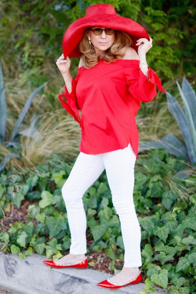 Falttering white pants with red blouse
